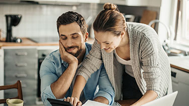 Couple working in kitchen 