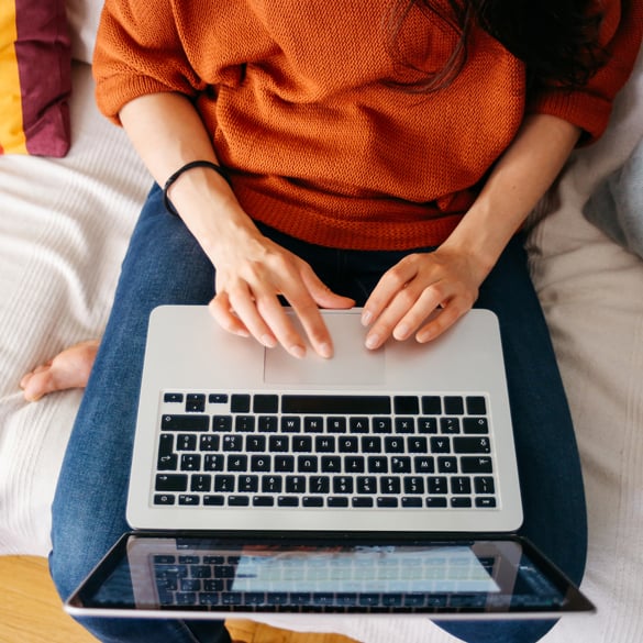 Electronic version of your Paper Bills with Salem Five Online Banking woman sitting on bed using laptop
