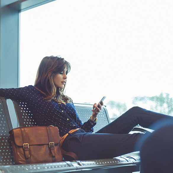 Woman receiving email and text alerts on mobile device